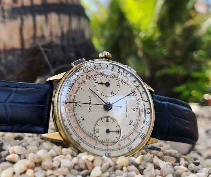 8. Cream dial, blue hands, gold case, black print, multicolored scales